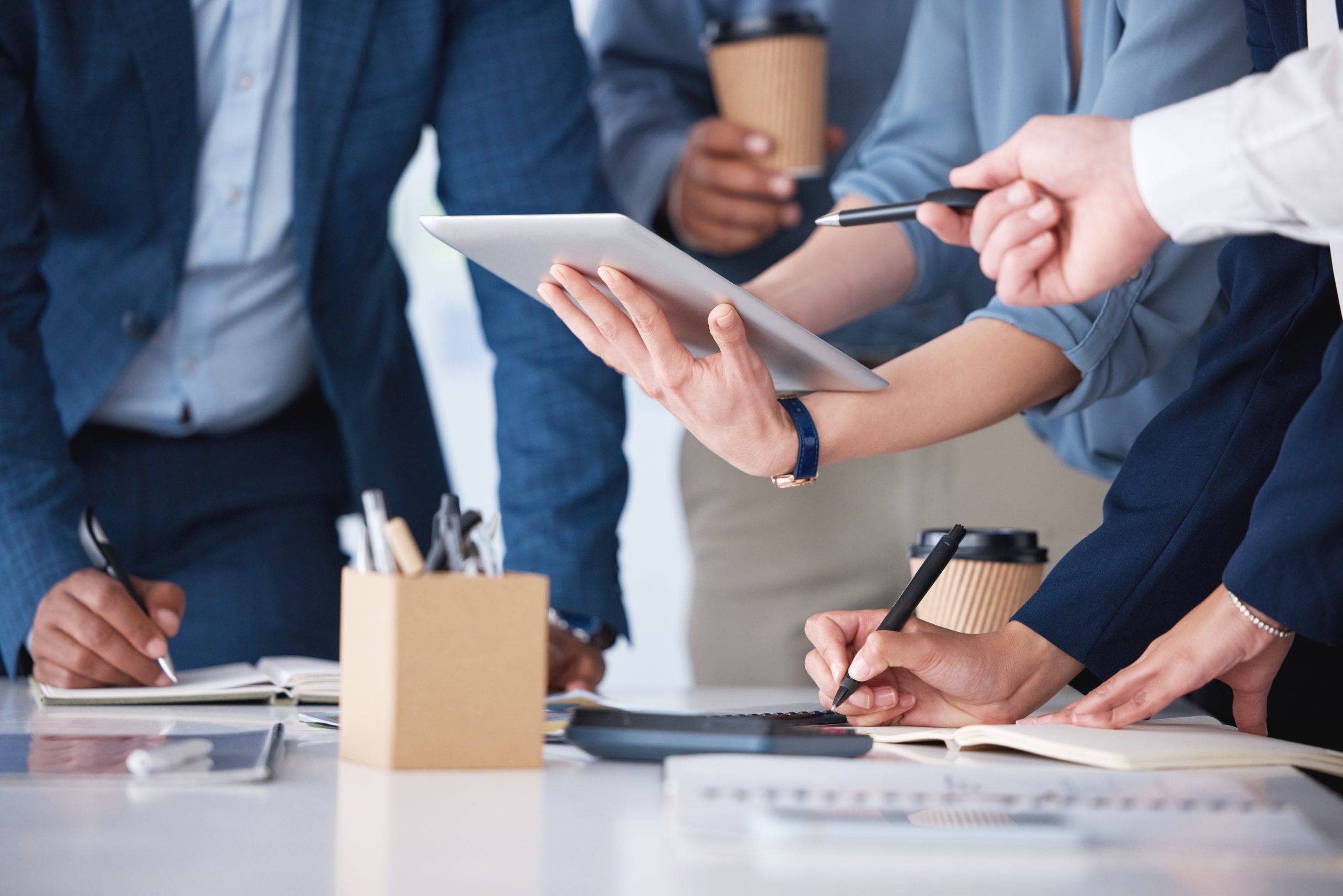 hands tablet business people by table with planning team schedule collaboration meeting office tech employee group calendar app project timeline with writing notes support