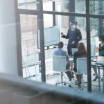 presenter teaching business people presentation sales report vision data analysis mentorship leadership group manager planning strategy screen monitor training meeting