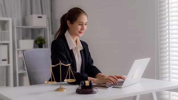 asian attorney using laptop computer drafting legal document office law firm justice system lawyer scales gavel table legal consultation 357951 6679